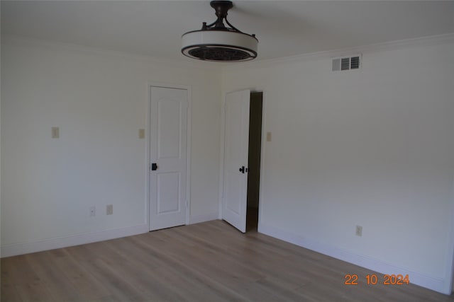 7575 Katy Fwy Unit 9, Houston, TX 77024 - empty room featuring wood finished floors, ornamental molding, and baseboards