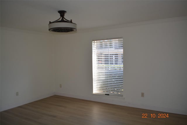 7575 Katy Fwy Unit 9, Houston, TX 77024 - empty room with crown molding, wood finished floors, and baseboards