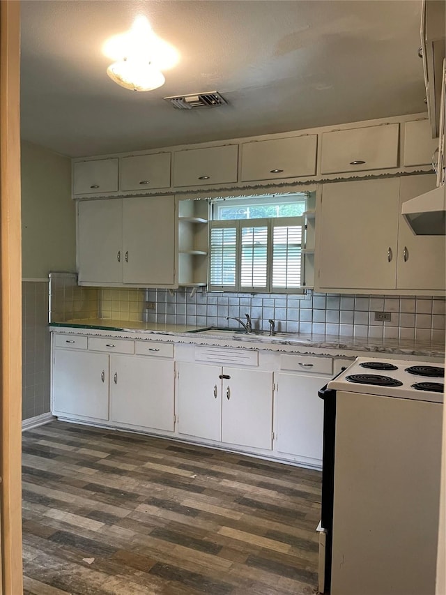 1116 Austin St, Rosenberg, TX 77471 - kitchen with white electric range oven, a sink, open shelves, dark wood finished floors, and white cabinetry