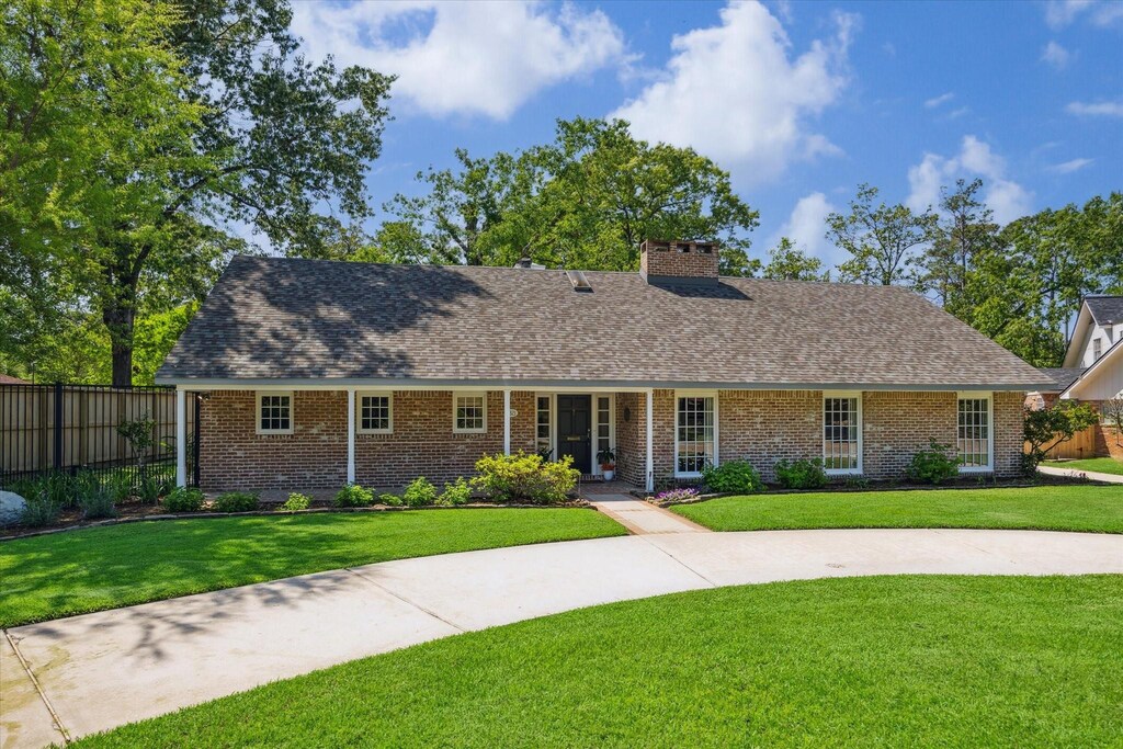 9321 Oakford Ct, Houston, TX 77024 - view of front facade with roof with shingles, a chimney, and brick siding