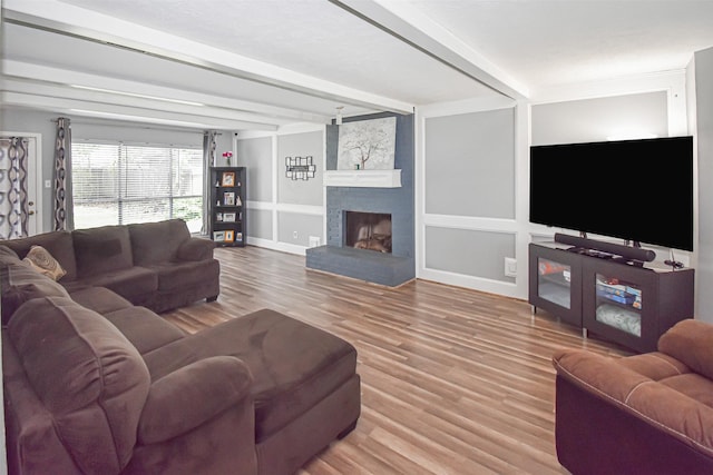 3638 Lost Oak Dr, Spring, TX 77388 - living room featuring wood finished floors, a brick fireplace, beamed ceiling, baseboards, and built in features
