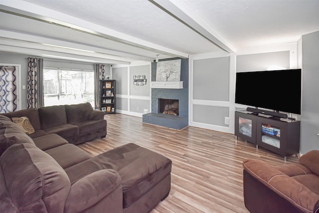 3638 Lost Oak Dr, Spring, TX 77388 - living area with light wood finished floors, baseboards, a brick fireplace, and beam ceiling