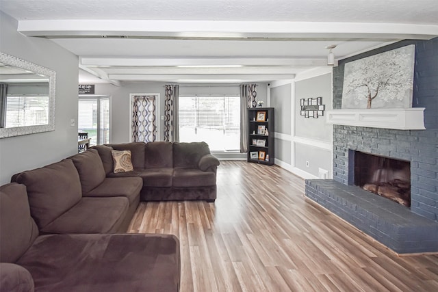 3638 Lost Oak Dr, Spring, TX 77388 - living room with beamed ceiling, light wood-style flooring, and a brick fireplace