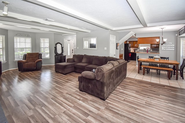3638 Lost Oak Dr, Spring, TX 77388 - living area with beamed ceiling, light wood finished floors, a chandelier, and baseboards