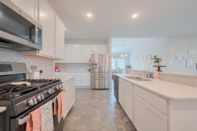 2446 Palisade Crest Dr, Rosharon, TX 77583 - kitchen with appliances with stainless steel finishes, a sink, tasteful backsplash, light countertops, and recessed lighting