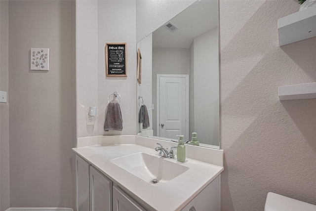 2446 Palisade Crest Dr, Rosharon, TX 77583 - bathroom with vanity, toilet, and a textured wall