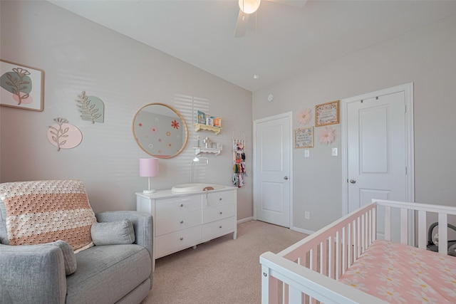 2446 Palisade Crest Dr, Rosharon, TX 77583 - bedroom with a nursery area, light carpet, vaulted ceiling, a ceiling fan, and baseboards
