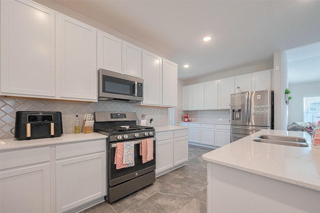 2446 Palisade Crest Dr, Rosharon, TX 77583 - kitchen with stainless steel appliances, a sink, white cabinets, decorative backsplash, and recessed lighting