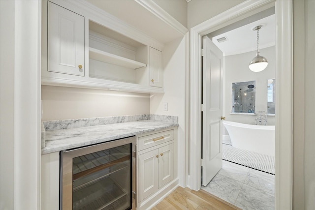 4654 Ingersoll St, Houston, TX 77027 - bar area featuring wine cooler and pendant lighting