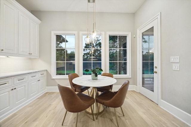 4654 Ingersoll St, Houston, TX 77027 - dining room featuring light wood finished floors, baseboards, and a chandelier