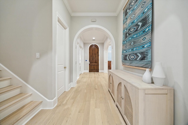 4654 Ingersoll St, Houston, TX 77027 - hallway featuring ornamental molding, light wood-style floors, arched walkways, baseboards, and stairs