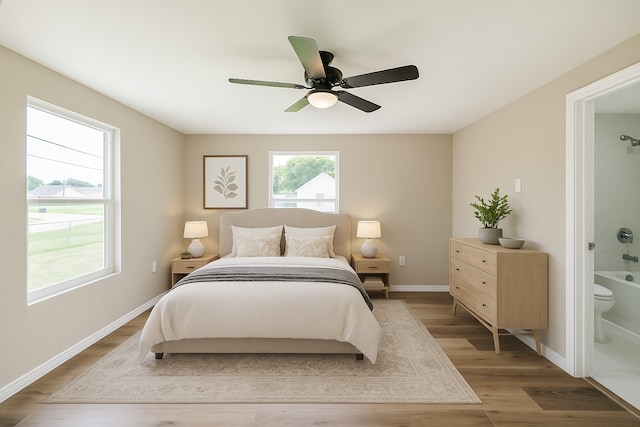 3108 Memel St, Houston, TX 77026 - bedroom with wood finished floors, ensuite bathroom, baseboards, and a ceiling fan