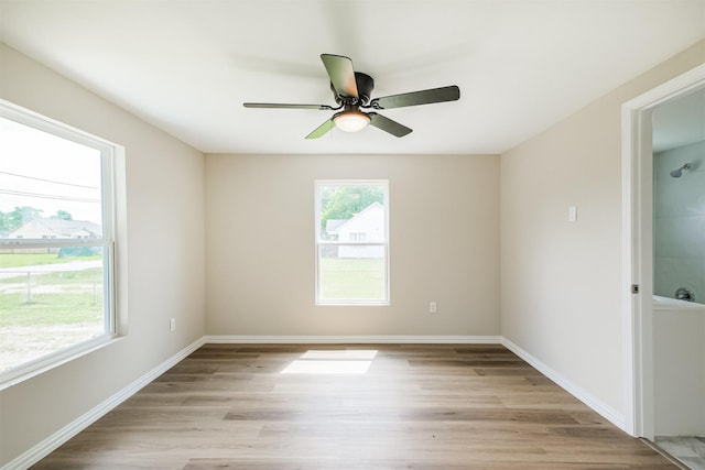 3108 Memel St, Houston, TX 77026 - unfurnished room with light wood-style floors, a ceiling fan, and baseboards