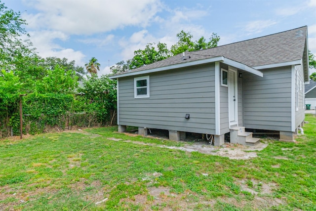 3108 Memel St, Houston, TX 77026 - back of property with entry steps, a lawn, and a shingled roof