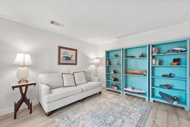 715 Timber Cove Dr, Seabrook, TX 77586 - living room with a textured ceiling, light wood finished floors, and ornamental molding