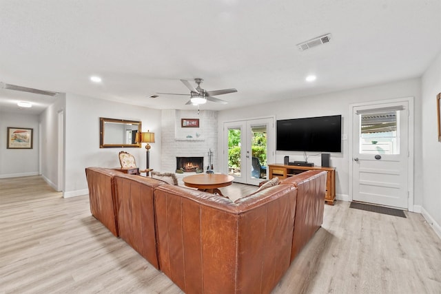 715 Timber Cove Dr, Seabrook, TX 77586 - living room featuring light wood finished floors, ceiling fan, a brick fireplace, recessed lighting, and french doors