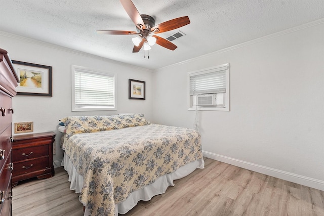715 Timber Cove Dr, Seabrook, TX 77586 - bedroom featuring light wood finished floors, crown molding, cooling unit, a textured ceiling, and ceiling fan