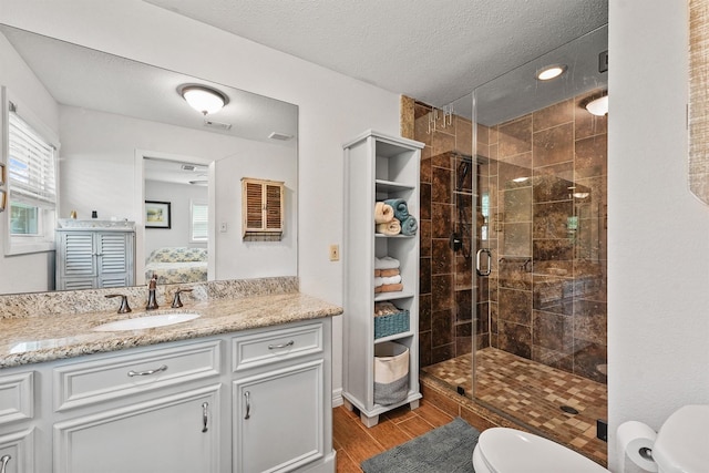 715 Timber Cove Dr, Seabrook, TX 77586 - full bathroom featuring vanity, a stall shower, healthy amount of natural light, wood finished floors, and a textured ceiling