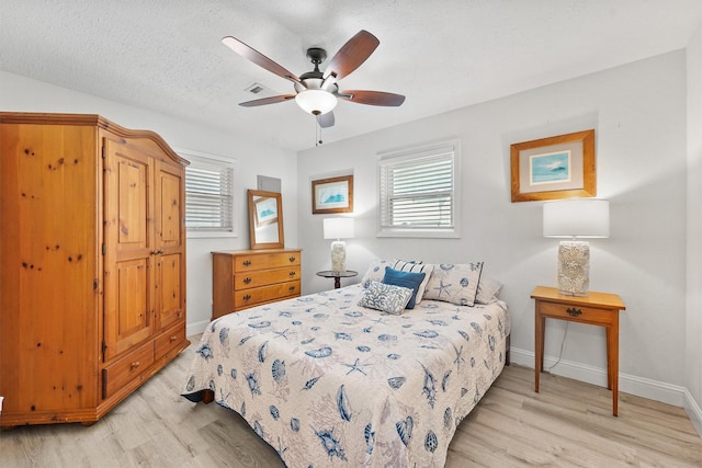715 Timber Cove Dr, Seabrook, TX 77586 - bedroom featuring light wood-style flooring, multiple windows, and a ceiling fan