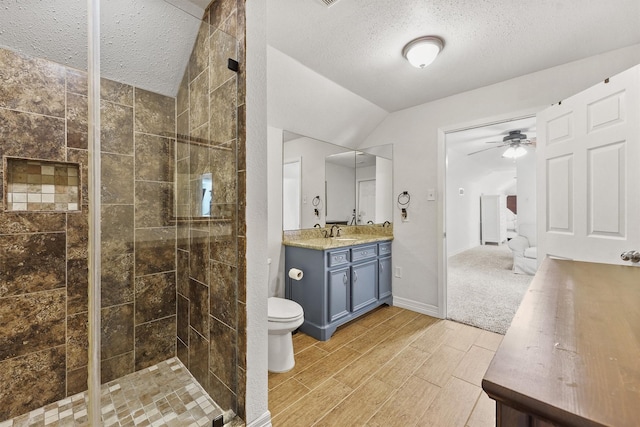 715 Timber Cove Dr, Seabrook, TX 77586 - bathroom featuring a textured ceiling, vanity, ceiling fan, a stall shower, and lofted ceiling