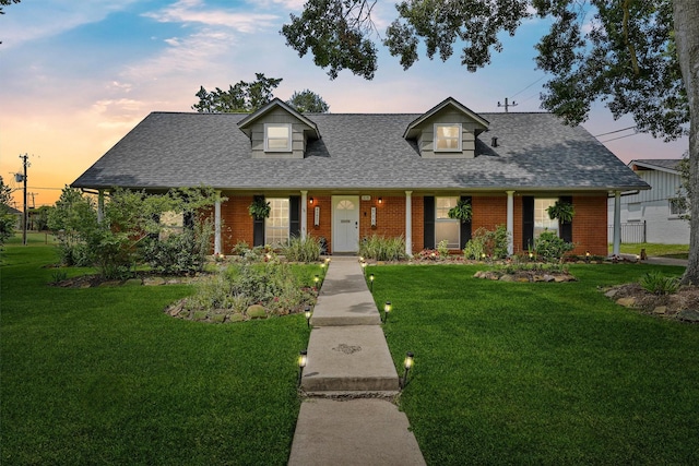 715 Timber Cove Dr, Seabrook, TX 77586 - cape cod-style house featuring brick siding, a shingled roof, and a yard