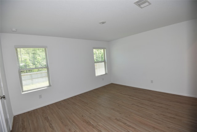 19591 Manduca Dr, New Caney, TX 77357 - unfurnished room featuring wood finished floors, baseboards, and a smoke detector