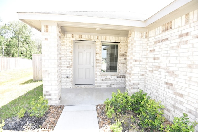 19591 Manduca Dr, New Caney, TX 77357 - doorway to property with brick siding, covered porch, and fence