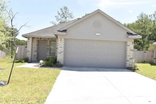 19591 Manduca Dr, New Caney, TX 77357 - ranch-style home featuring driveway, an attached garage, brick siding, and roof with shingles