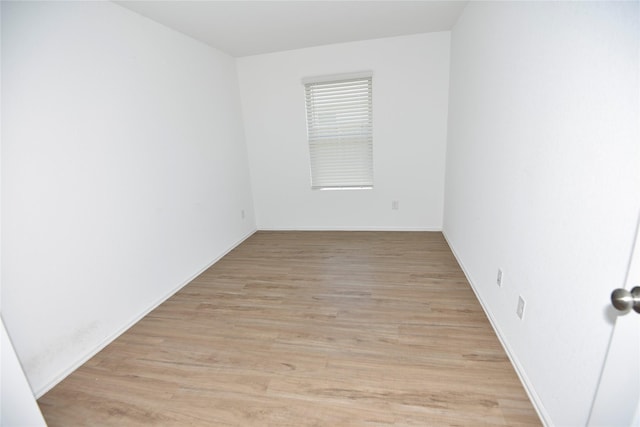 19591 Manduca Dr, New Caney, TX 77357 - unfurnished room with light wood-type flooring and baseboards