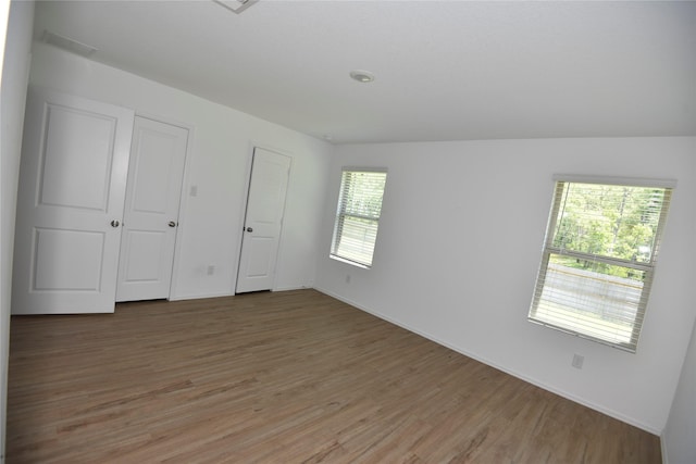 19591 Manduca Dr, New Caney, TX 77357 - unfurnished bedroom featuring light wood-type flooring and baseboards