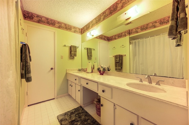 3819 Ridgeview Dr, Missouri City, TX 77459 - full bath with tile patterned floors, double vanity, a textured ceiling, and baseboards
