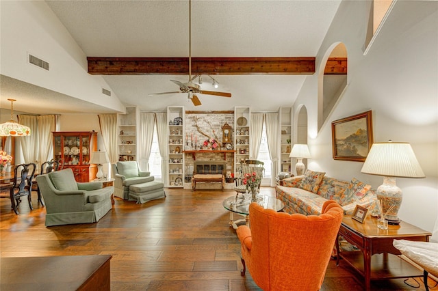 3819 Ridgeview Dr, Missouri City, TX 77459 - living room with a ceiling fan, hardwood / wood-style floors, a fireplace, a textured ceiling, and arched walkways