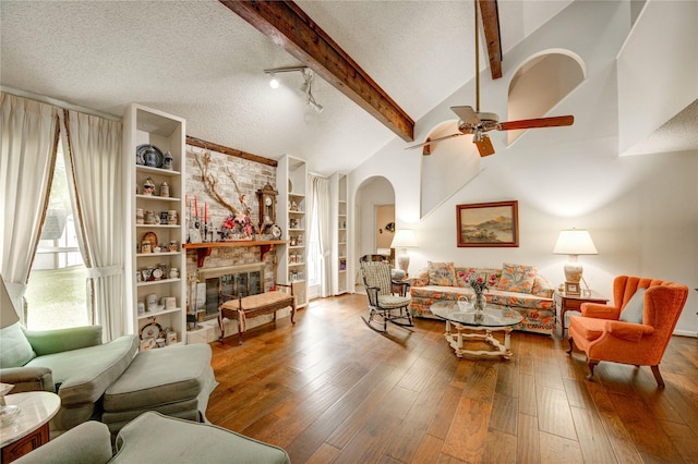 3819 Ridgeview Dr, Missouri City, TX 77459 - living room with arched walkways, a textured ceiling, ceiling fan, wood-type flooring, and built in features