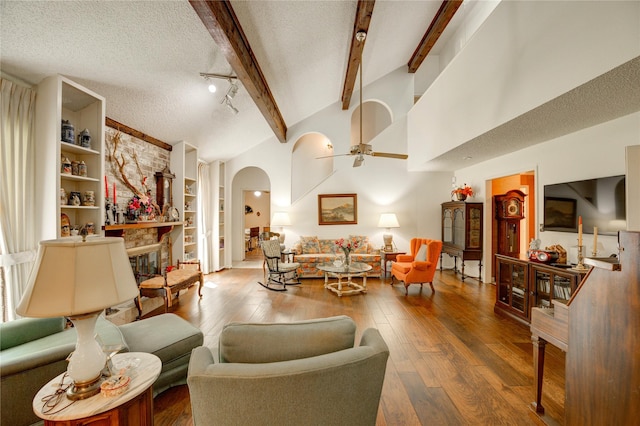 3819 Ridgeview Dr, Missouri City, TX 77459 - living area with a ceiling fan, hardwood / wood-style flooring, a textured ceiling, arched walkways, and built in features