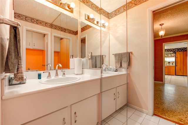 3819 Ridgeview Dr, Missouri City, TX 77459 - full bathroom featuring double vanity, baseboards, a textured ceiling, and tile patterned floors