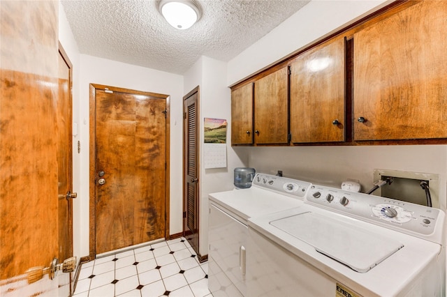3819 Ridgeview Dr, Missouri City, TX 77459 - laundry room with cabinet space, washing machine and dryer, light flooring, a textured ceiling, and baseboards