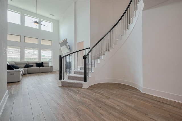 23604 Olive Creek Ln, New Caney, TX 77357 - foyer entrance with wood finished floors, stairs, a high ceiling, and baseboards