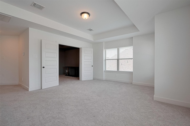 23604 Olive Creek Ln, New Caney, TX 77357 - unfurnished bedroom with light carpet, baseboards, and a raised ceiling