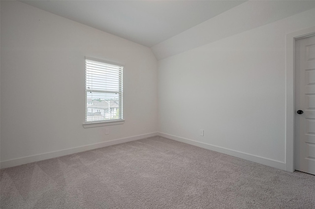 23604 Olive Creek Ln, New Caney, TX 77357 - empty room with light carpet, baseboards, and lofted ceiling