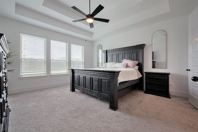 23604 Olive Creek Ln, New Caney, TX 77357 - bedroom featuring a tray ceiling, carpet flooring, and baseboards