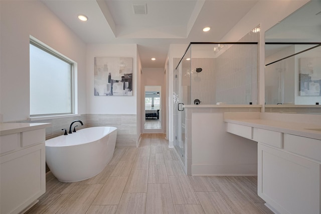 23604 Olive Creek Ln, New Caney, TX 77357 - bathroom with healthy amount of natural light, a soaking tub, a stall shower, vanity, and recessed lighting