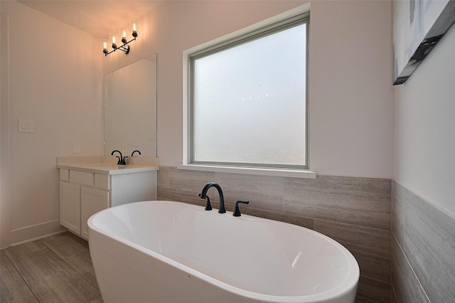 23604 Olive Creek Ln, New Caney, TX 77357 - bathroom with vanity, a soaking tub, and tile walls