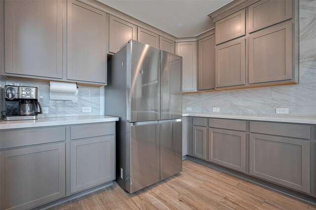 23604 Olive Creek Ln, New Caney, TX 77357 - kitchen with freestanding refrigerator, gray cabinets, and backsplash