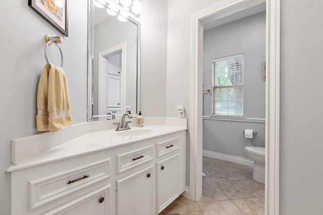 60 Fairfield Dr, Montgomery, TX 77356 - bathroom featuring toilet, vanity, tile patterned flooring, and baseboards