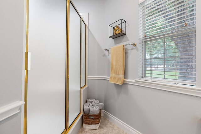 60 Fairfield Dr, Montgomery, TX 77356 - bathroom featuring a shower with shower door and baseboards