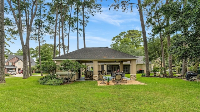 60 Fairfield Dr, Montgomery, TX 77356 - rear view of property featuring ceiling fan, a lawn, a patio area, and roof with shingles