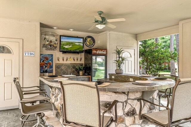60 Fairfield Dr, Montgomery, TX 77356 - dining space with bar with sink, a ceiling fan, and plenty of natural light