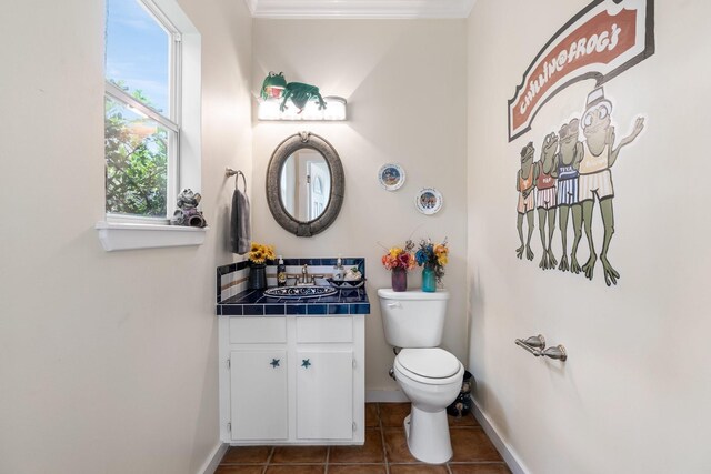 60 Fairfield Dr, Montgomery, TX 77356 - half bathroom with toilet, tile patterned floors, vanity, baseboards, and crown molding