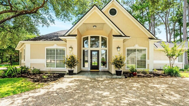60 Fairfield Dr, Montgomery, TX 77356 - view of exterior entry featuring stucco siding
