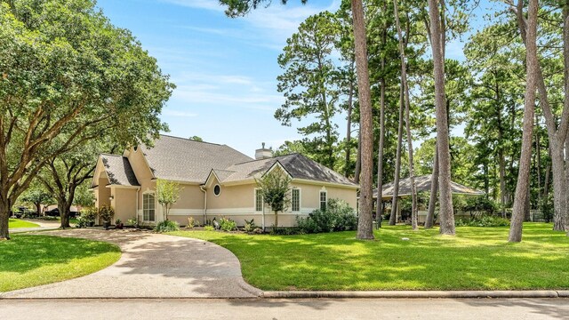 60 Fairfield Dr, Montgomery, TX 77356 - view of front of house featuring stucco siding, a gazebo, a front lawn, and a chimney